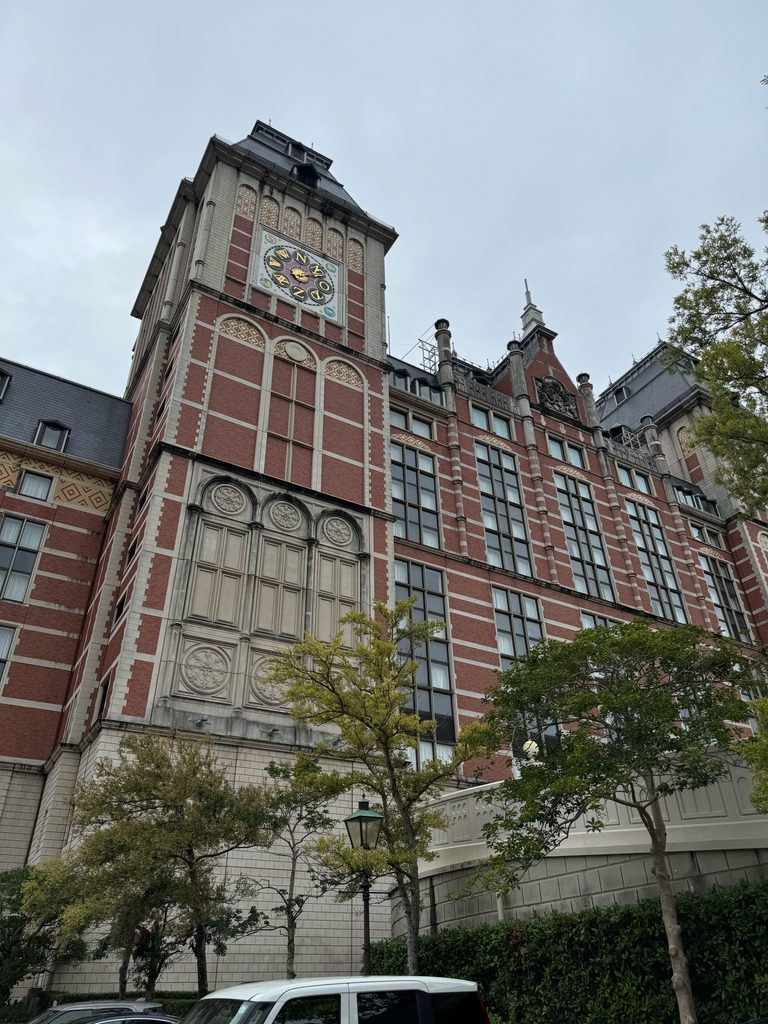 Red-brick clock tower of Hotel Okura JR Huis Ten Bosch under a cloudy sky