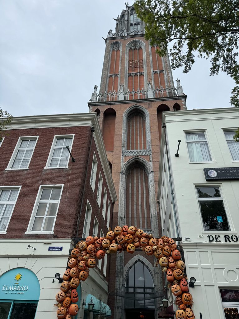 European-style street with a brick tower and an autumn pumpkin arch at Huis Ten Bosch