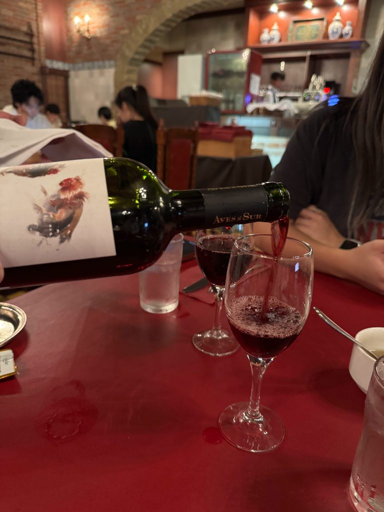 Pouring red wine at the lemon steak restaurant in Sasebo