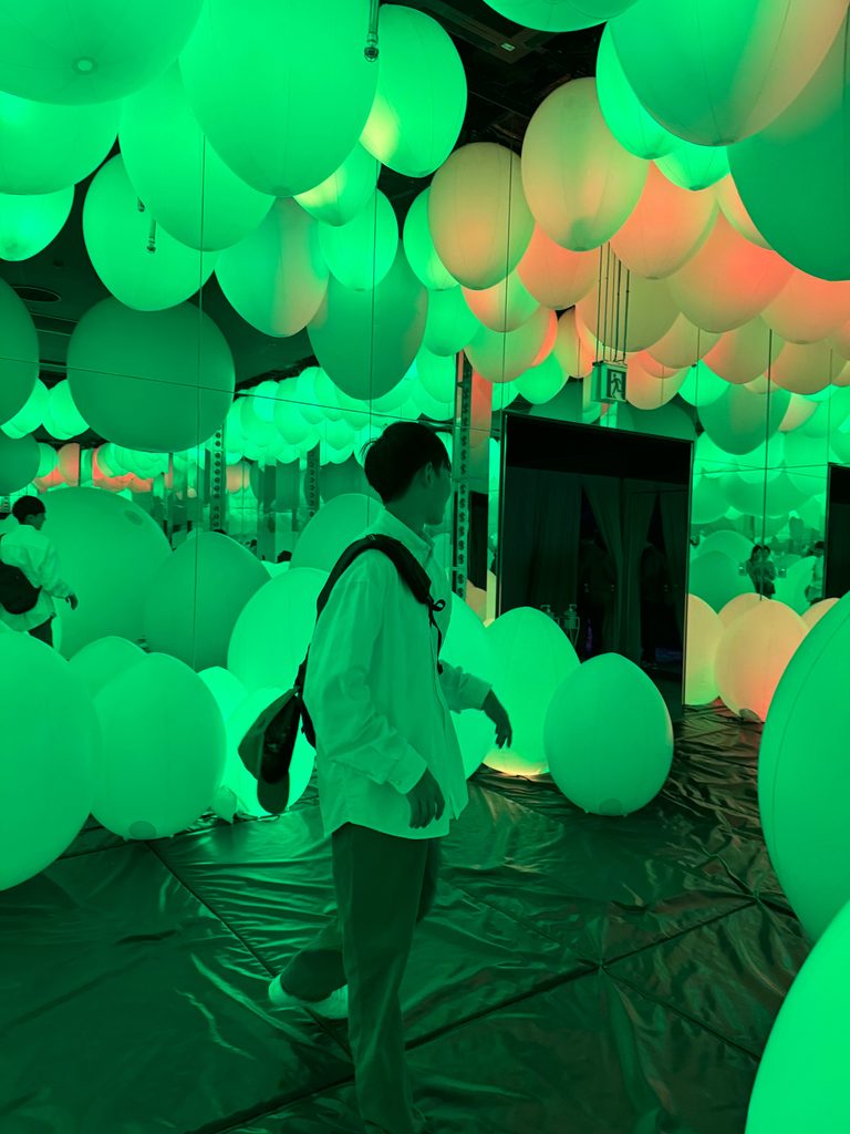 Walking among softly glowing orbs that change colour at teamLab