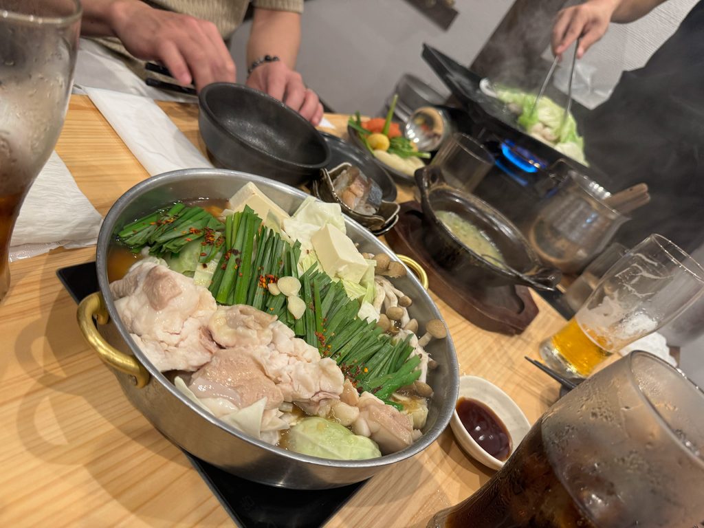 A bubbling pot of Fukuoka motsunabe packed with chives and cabbage