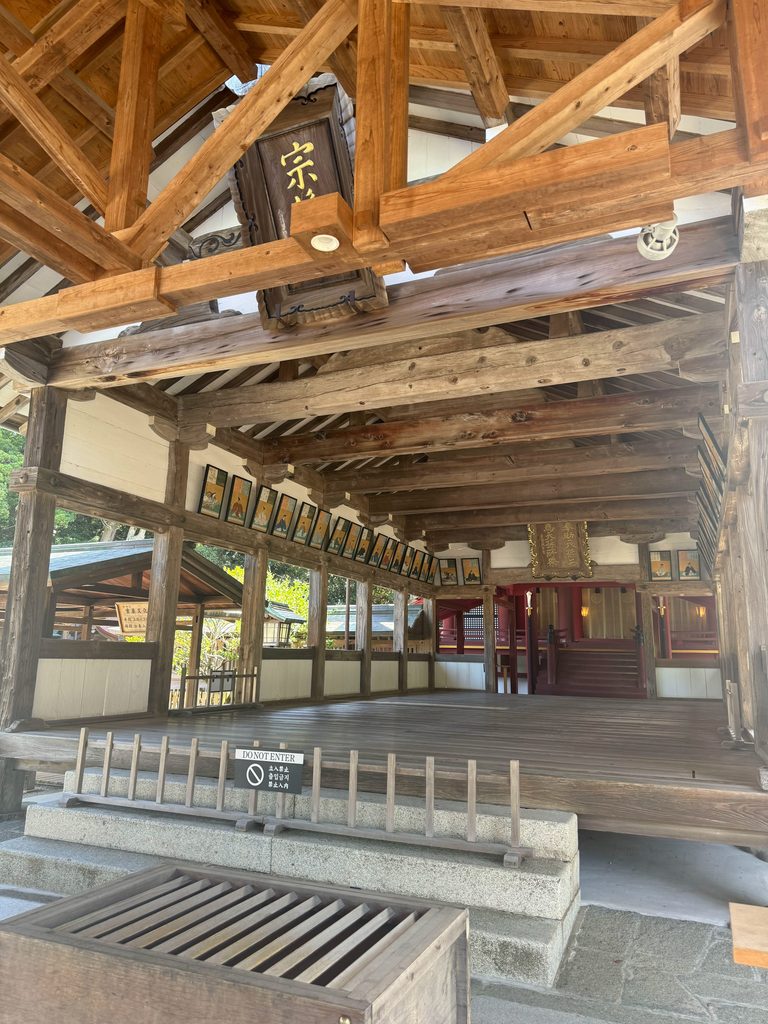 The wooden worship hall of Munakata Taisha seen from the covered approach