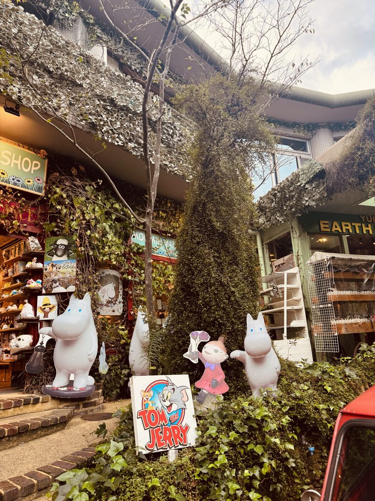 Moomin figures and a Tom and Jerry sign outside a character goods shop in Yufuin