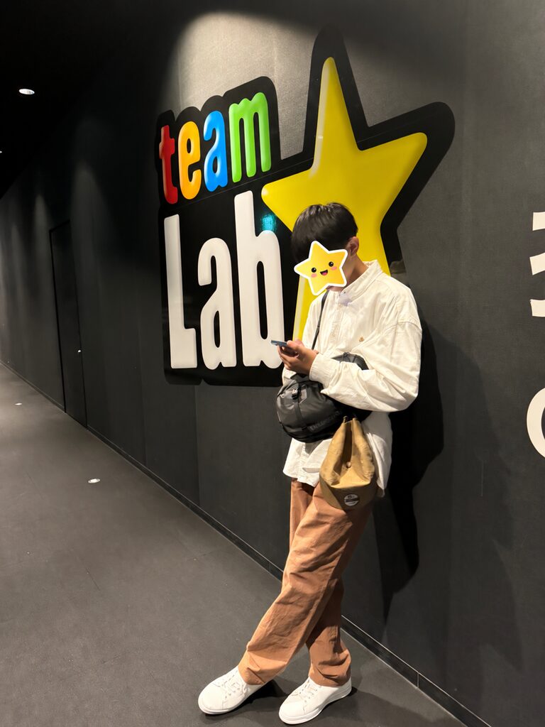 Standing in front of the teamLab sign at the entrance to the museum in Fukuoka
